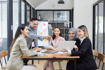 Obraz premium Team of Asian business people and working together in office, Startup projects and business presentation at meeting room.