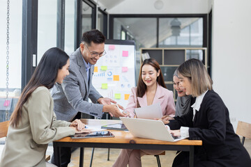 Team of Asian business people and working together in office, Startup projects and business presentation at meeting room.