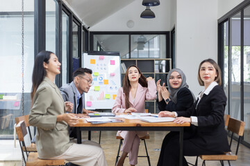 Team of Asian business people and working together in office, Startup projects and business presentation at meeting room.