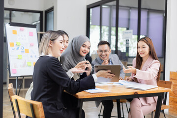 Team of Asian business people and working together in office, Startup projects and business presentation at meeting room.