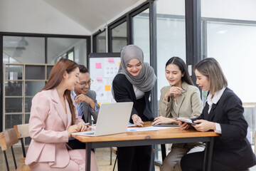 Team of Asian business people and working together in office, Startup projects and business presentation at meeting room.