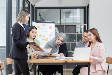 Team of Asian business people and working together in office, Startup projects and business presentation at meeting room.