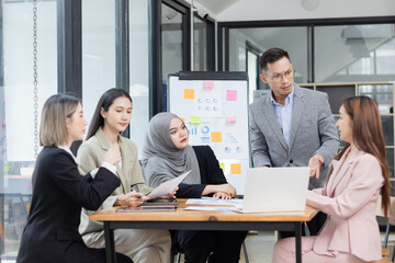 Team of Asian business people and working together in office, Startup projects and business presentation at meeting room.