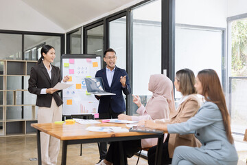 Team of Asian business people and working together in office, Startup projects and business presentation at meeting room.