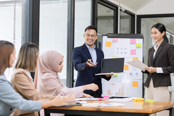 Fototapeta premium Team of Asian business people and working together in office, Startup projects and business presentation at meeting room.