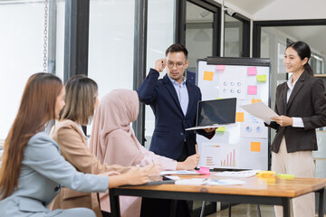 Team of Asian business people and working together in office, Startup projects and business presentation at meeting room.