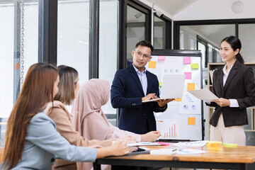 Team of Asian business people and working together in office, Startup projects and business presentation at meeting room.