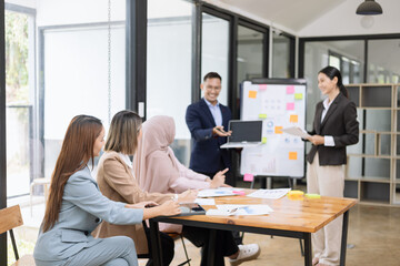 Team of Asian business people and working together in office, Startup projects and business presentation at meeting room.