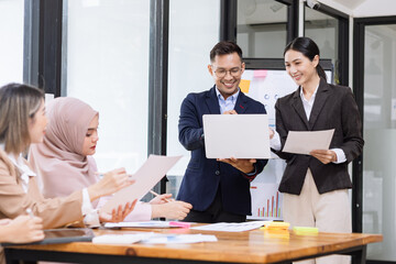 Team of Asian business people and working together in office, Startup projects and business presentation at meeting room.