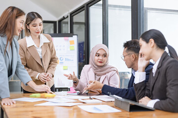 Team of Asian business people and working together in office, Startup projects and business presentation at meeting room.