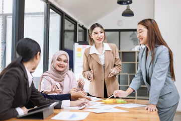 Team of Asian business people and working together in office, Startup projects and business presentation at meeting room.