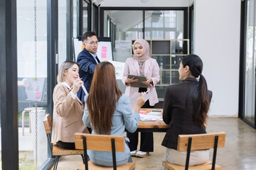 Team of Asian business people and working together in office, Startup projects and business presentation at meeting room.