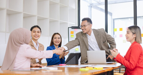 Asian business teamwork making handshake with partner in meeting room, Greeting and corporate business handshake, 