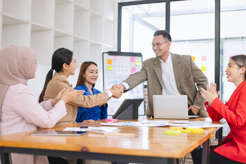 Asian business teamwork making handshake with partner in meeting room, Greeting and corporate business handshake, 