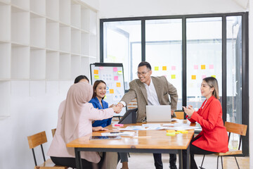 Asian business teamwork making handshake with partner in meeting room, Greeting and corporate business handshake, 