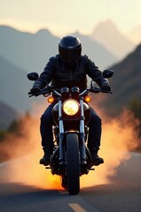 Motorcycle rider riding on the road in the mountains at sunset.