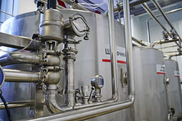 Obraz premium Metal pipes with different fasteners at the factory.