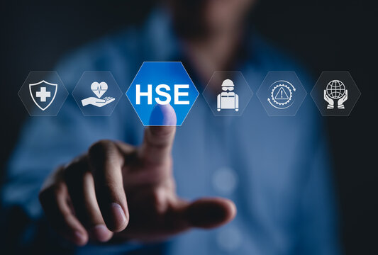 Health, Safety, and Environment (HSE) Management Concept. A person touching on HSE wording, icons for health, safety, environmental protection, risk management, and HSE protocols in workplace safety.