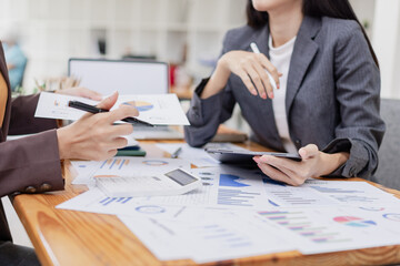 Asian businesswoman working on laptop with finances analysis report at desk in office, business financing, accounting banking,