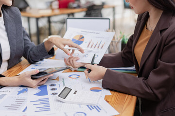 Asian businesswoman working on laptop with finances analysis report at desk in office, business financing, accounting banking,