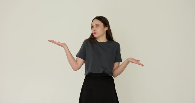 Young woman gesturing with scales hands and making choice