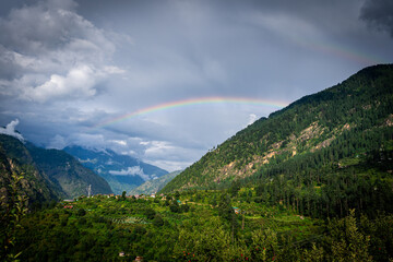 Beautiful mountains of Parvati Valley with a rainbow in Himachal Pradesh, india