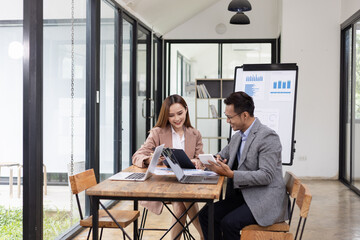 Two business people working with business financing accounting banking and laptop with finances...