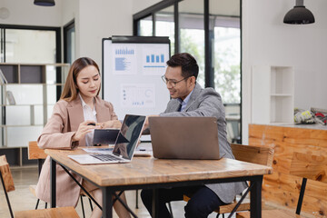 Two business people working with business financing accounting banking and laptop with finances...