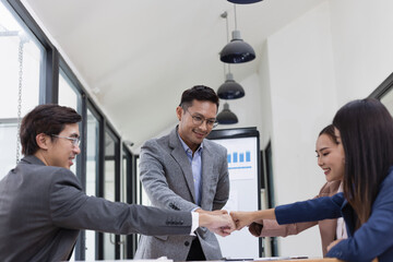 Asian business teamwork working with analysis report and advisor showing plan, Financial analysis and Marketing teamwork concept.