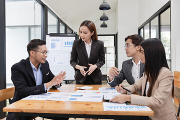 Asian business teamwork working with analysis report and advisor showing plan, Financial analysis and Marketing teamwork concept.