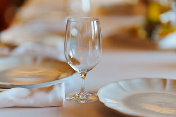 An empty wine glass on a table served for a banquet. 