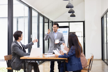 Asian business teamwork working with analysis report and advisor showing plan, Financial analysis and Marketing teamwork concept.