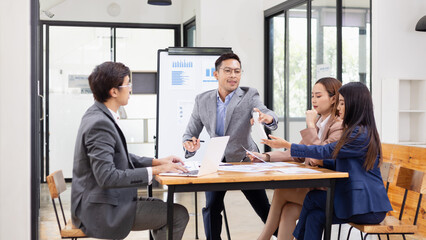 Asian business teamwork working with analysis report and advisor showing plan, Financial analysis and Marketing teamwork concept.