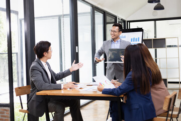 Asian business teamwork working with analysis report and advisor showing plan, Financial analysis and Marketing teamwork concept.
