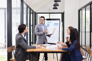 Asian business teamwork working with analysis report and advisor showing plan, Financial analysis and Marketing teamwork concept.
