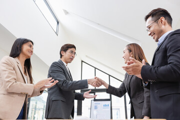 Asian business people shaking hands, Startup projects, Business partners handshaking after...
