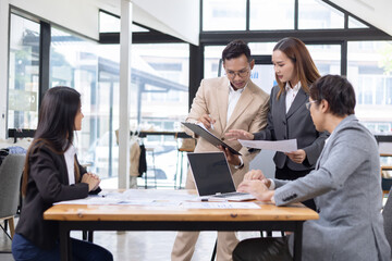 Asian business teamwork working with analysis report and advisor showing plan, Financial analysis and Marketing teamwork concept.