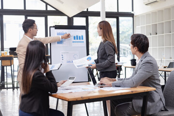 Asian business teamwork working with analysis report and advisor showing plan, Financial analysis and Marketing teamwork concept.