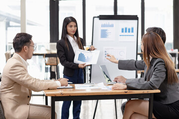 Fototapeta premium Asian business teamwork working with analysis report and advisor showing plan, Financial analysis and Marketing teamwork concept.