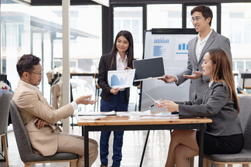 Asian business teamwork working with analysis report and advisor showing plan, Financial analysis and Marketing teamwork concept.