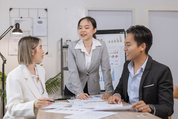 Asian business teamwork working on digital tablet with analysis report and advisor showing plan, Financial analysis and Marketing teamwork concept.