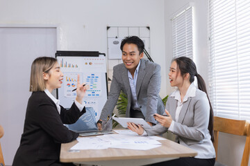 Asian business teamwork working on digital tablet with analysis report and advisor showing plan, Financial analysis and Marketing teamwork concept.