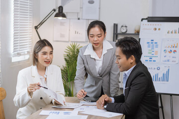Asian business teamwork working on digital tablet with analysis report and advisor showing plan, Financial analysis and Marketing teamwork concept.