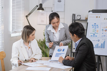 Fototapeta premium Asian business teamwork working on digital tablet with analysis report and advisor showing plan, Financial analysis and Marketing teamwork concept.