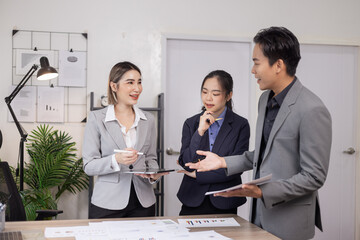 Asian business teamwork working on digital tablet with analysis report and advisor showing plan, Financial analysis and Marketing teamwork concept.