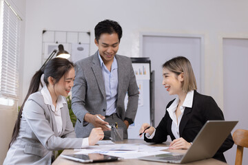 Fototapeta premium Asian business teamwork working on digital tablet with analysis report and advisor showing plan, Financial analysis and Marketing teamwork concept.