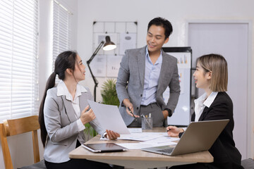 Asian business teamwork working on digital tablet with analysis report and advisor showing plan, Financial analysis and Marketing teamwork concept.