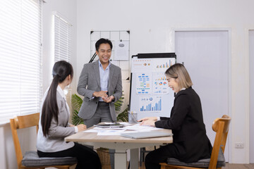 Asian business teamwork working on digital tablet with analysis report and advisor showing plan, Financial analysis and Marketing teamwork concept.