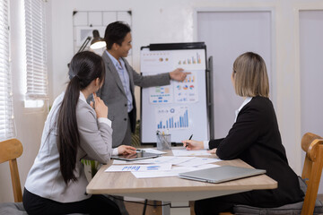 Fototapeta premium Asian business teamwork working on digital tablet with analysis report and advisor showing plan, Financial analysis and Marketing teamwork concept.