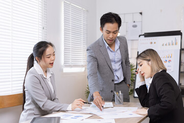 Asian business teamwork working on digital tablet with analysis report and advisor showing plan, Financial analysis and Marketing teamwork concept.